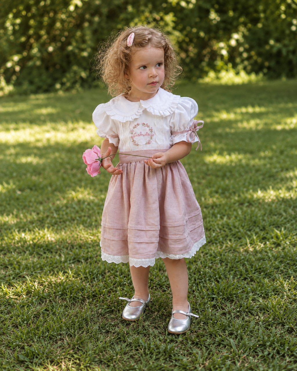 Girl in white and dusty pink embroidered linen dress