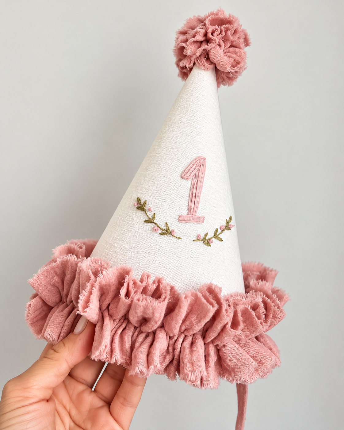 Dusty rose and ivory first birthday party hat with embroidered number 1, pom pom and ruffled trim